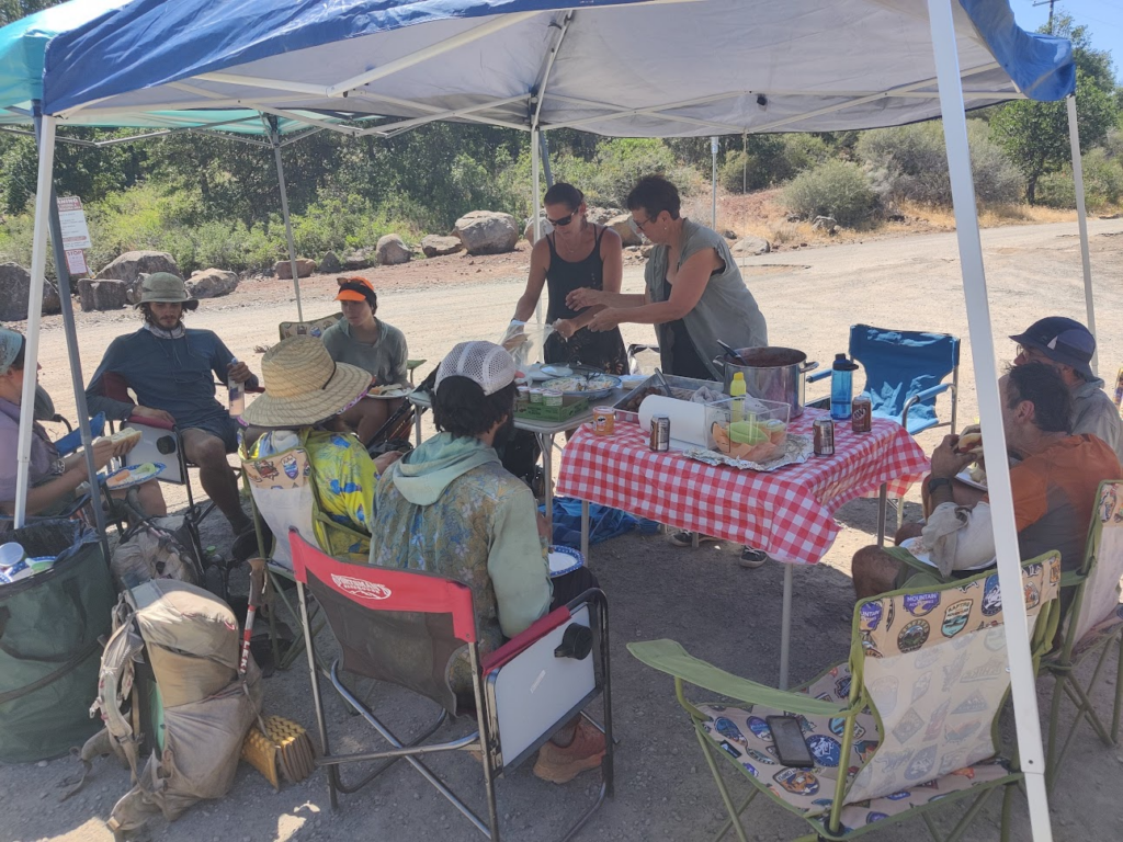 trail magic in Hat Creek Rim under an awning with a bunch of other hikers