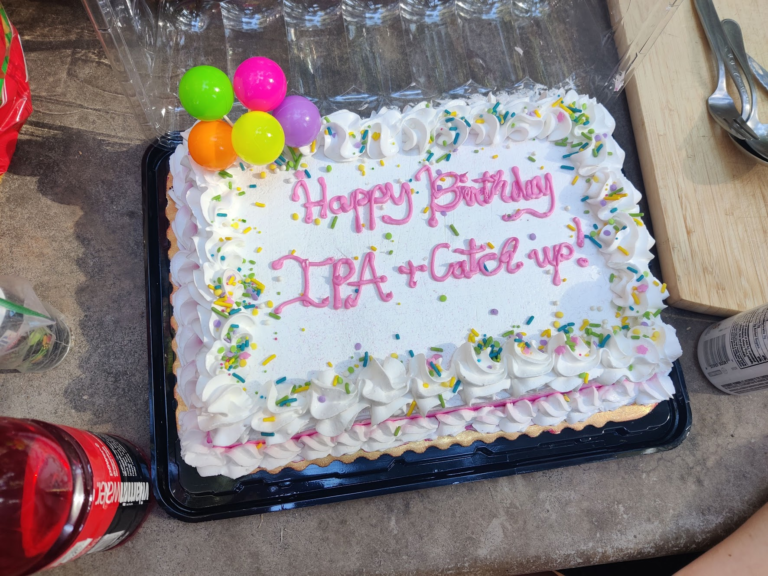 Birthday cake saying "Happy Birthday IPA + Catch Up"