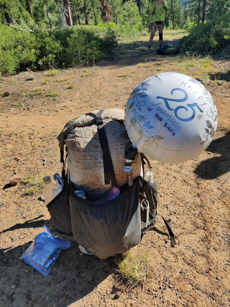 My very dirty backpack with the birthday balloon attached to it.