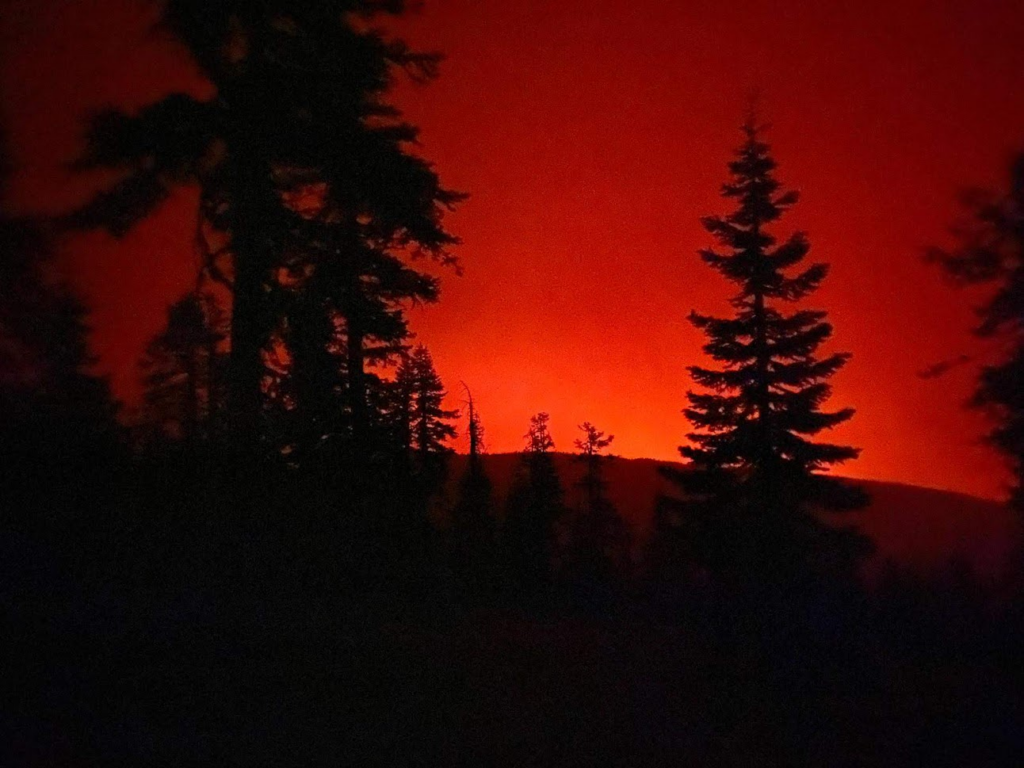 The red glow of the wildfire at night