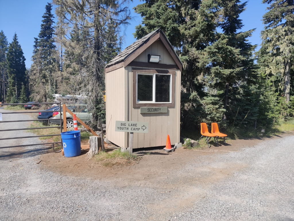 Booth pointing to Big Lake Youth Camp